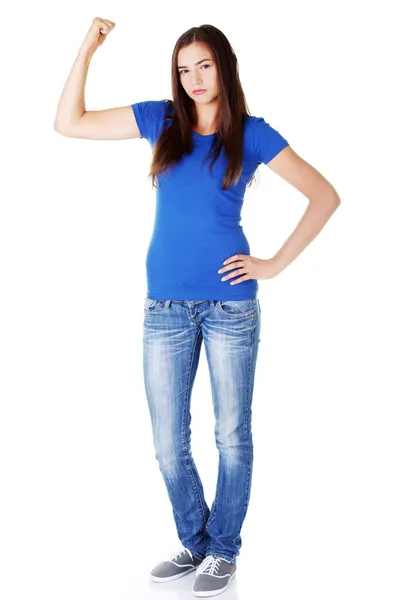 Young beautiful woman showing her strength and muscle. — Stock Photo, Image