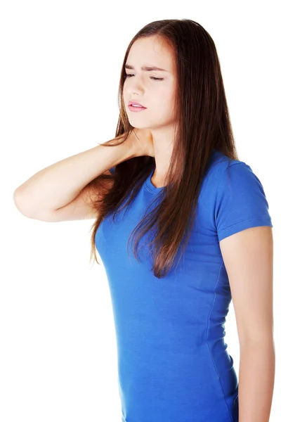 Young casual woman is touching her neck. — Stock Photo, Image