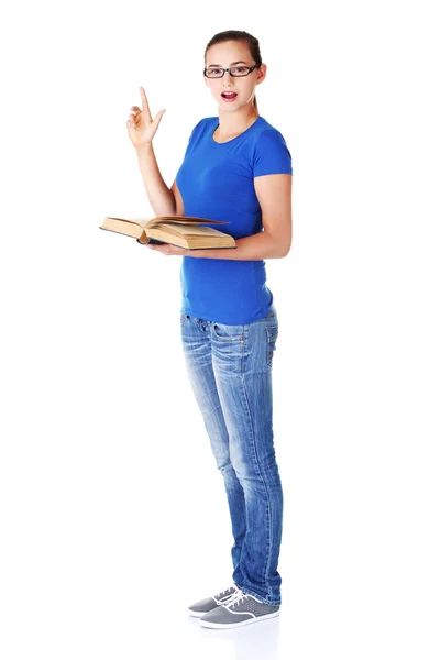 Jovem estudante casual mulher com livro e apontando para cima . — Fotografia de Stock