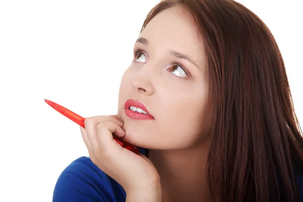 Beautiful woman with pen thinking and looking up. — Stock Photo, Image