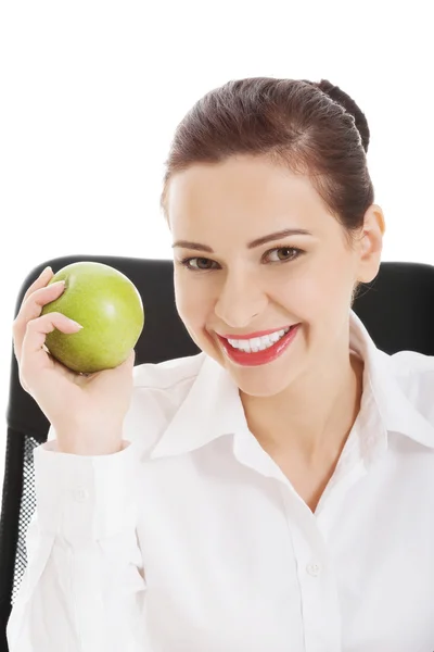 Young beautiful business woman holding an apple. Stock Photo