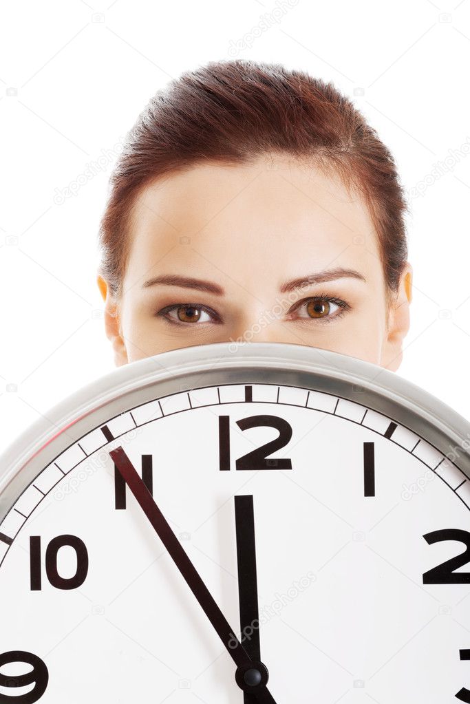 Young beautiful business woman holding clock.