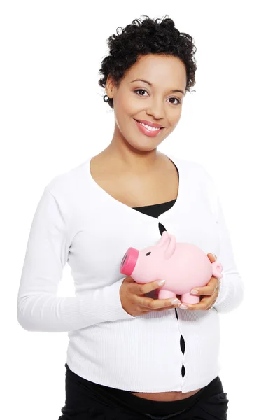 Pregnant woman holding piggy bank — Stock Photo, Image