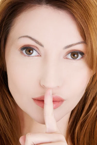 Vrouw met vinger op haar lippen. — Stockfoto
