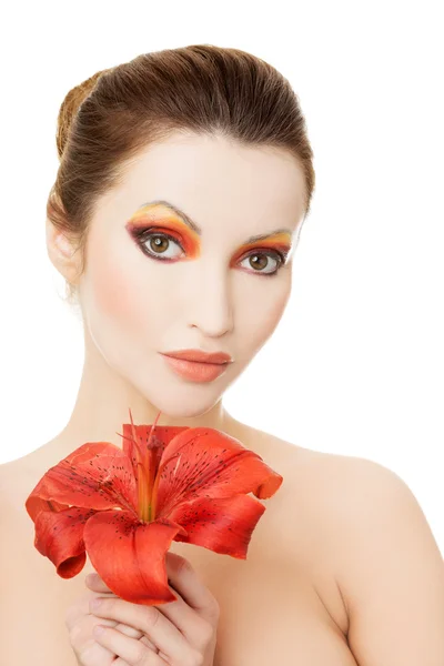 Beautiful woman with a red lily — Stock Photo, Image