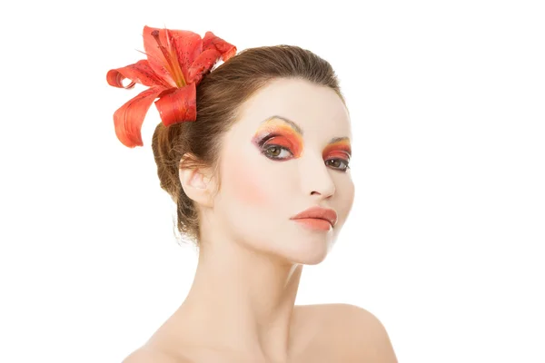 Beautiful woman with a red lily — Stock Photo, Image