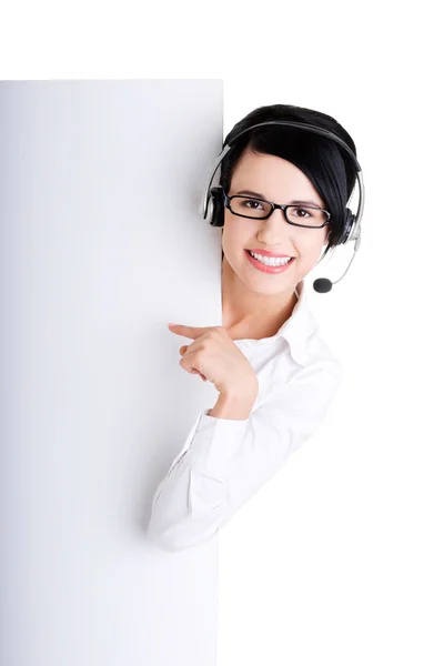 Call center worker holding blank sign board — Stock Photo, Image