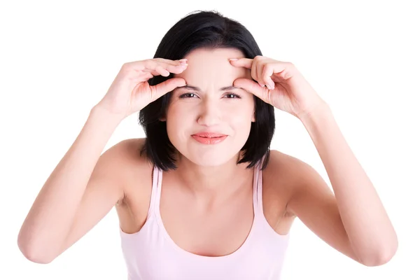 Beautiful shocked woman checking her wrinkles — Stock Photo, Image