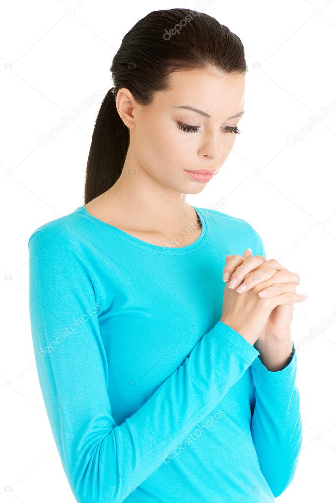 Portrait of a young caucasian woman praying