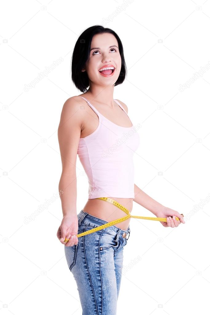 Happy young woman measuring her waist