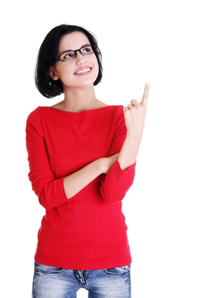 Excited young woman pointing on copy space — Stock Photo, Image