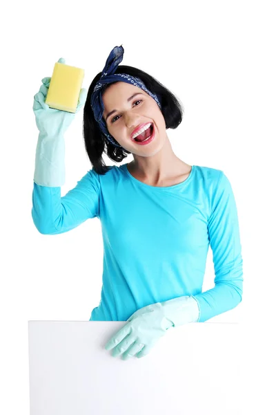 Cleaning woman showing blank sign board. — Stock Photo, Image