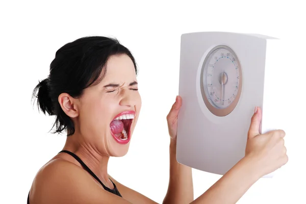 Frustrated woman with scale — Stock Photo, Image