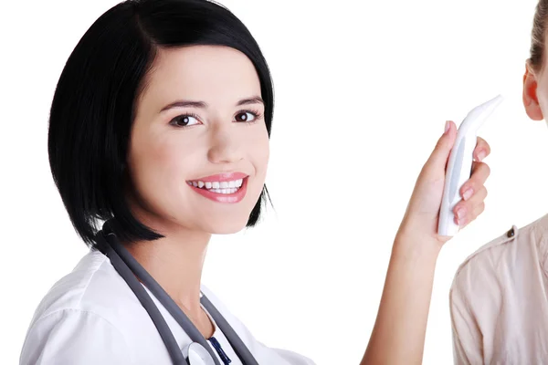 Female doctor checking temperature of her patient — Stock Photo, Image