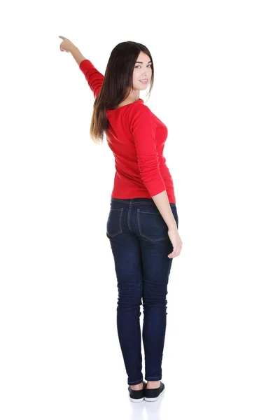Happy young woman pointing on copy space — Stock Photo, Image