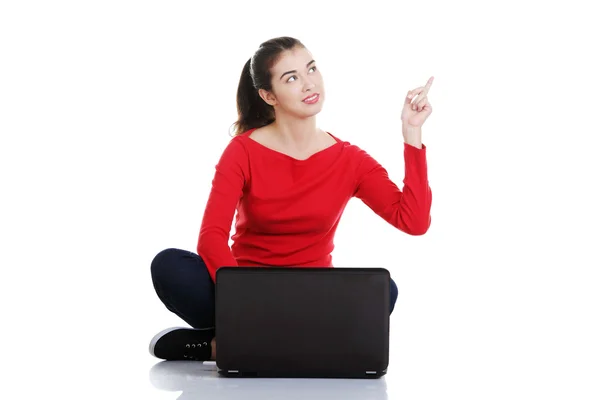 Working on laptop computer and pointing up — Stock Photo, Image