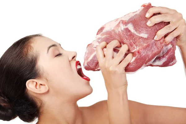 Young beautiful woman eating raw meat. — Stok fotoğraf