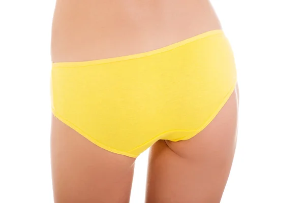 Slim tanned woman's body in yellow panties. — Stock Photo, Image