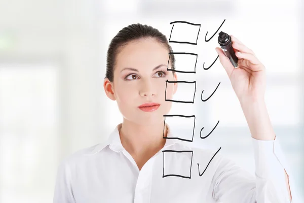 Young businesswoman writing something — Stock Photo, Image