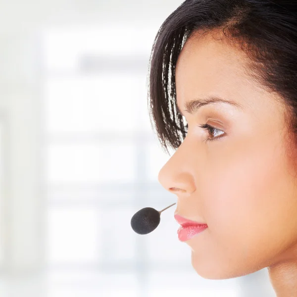 Beautiful young call-center assistant smiling — Stock Photo, Image