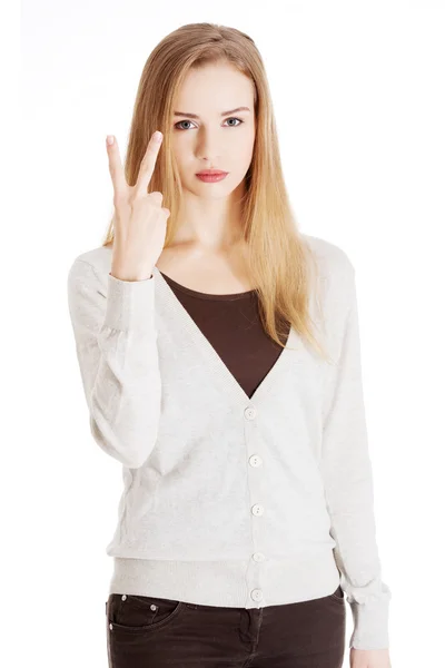 Beautiful casual woman is showing victory sign, two fingers. — Stock Photo, Image