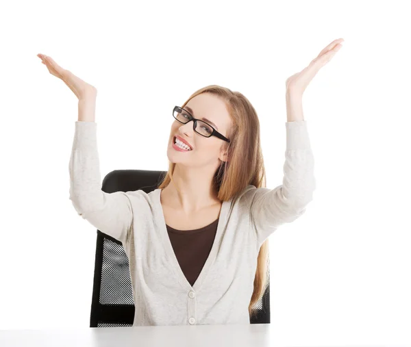 Beautiful casual woman sitting and pointing up, advertising. — Stock Photo, Image