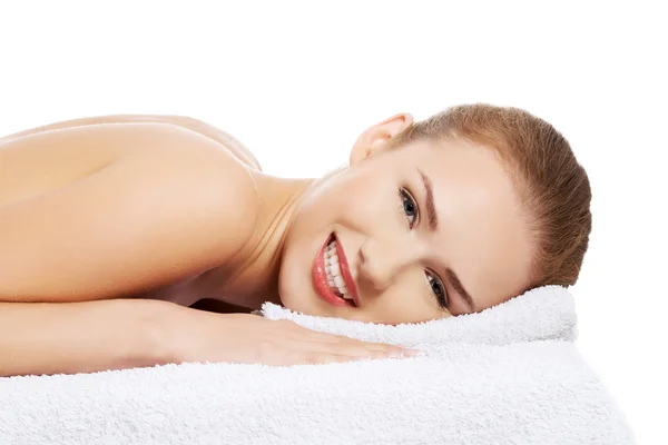 Beautiful caucasian naked woman lying on a massage table — Stock Photo, Image