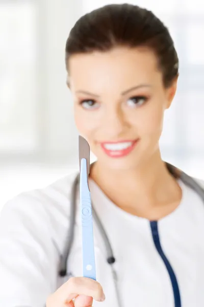 Female doctor with scalpel. Stock Photo