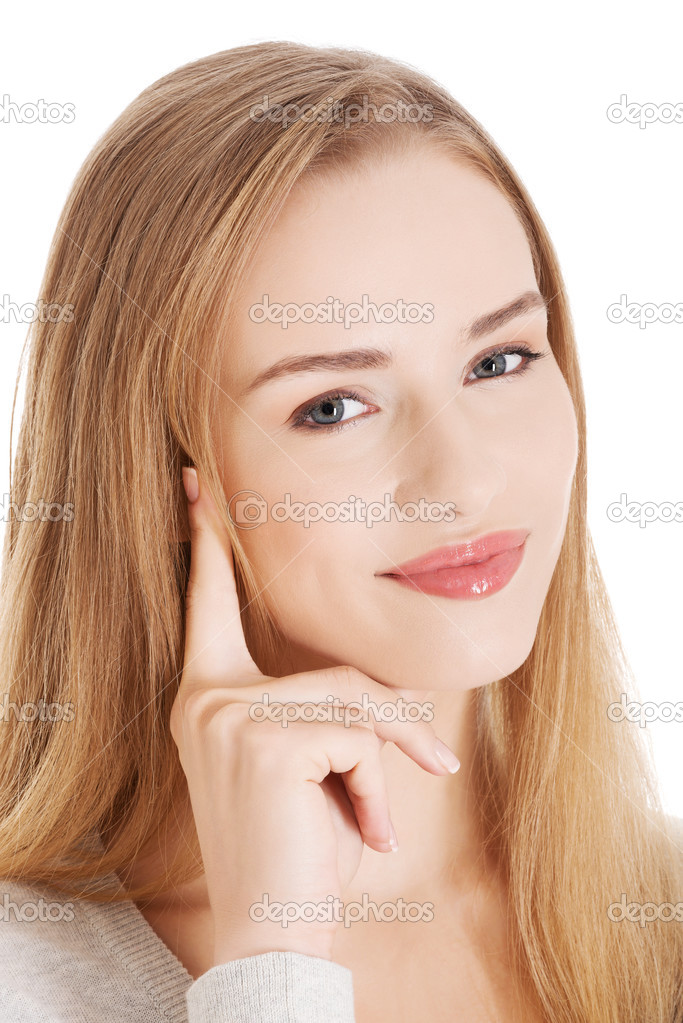 Portrait of beautiful smiling woman with her finger touching her face