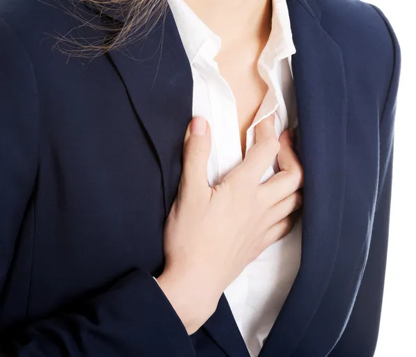 Hermosa mujer de negocios tocándose el pecho, sintiéndose mal . — Foto de Stock