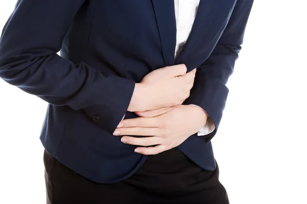 Beautiful business woman is touching her stomach. — Stock Photo, Image
