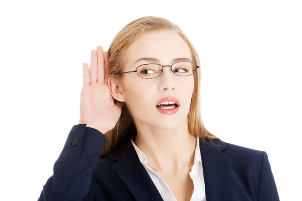 Beautiful business woman is over-hearing, touching her ear. — Stock Photo, Image