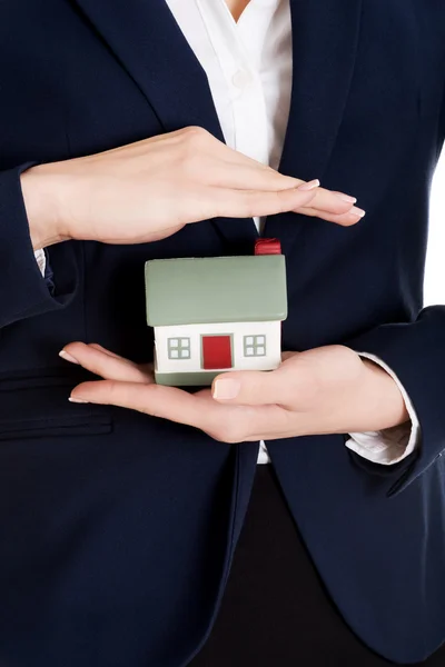 Close up on house modal in business woman's hands. — Stock Photo, Image