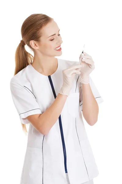 Beautiful young nurse or doctor with needle, shot ready to apply — Stock Photo, Image