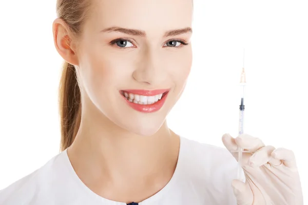 Beautiful young nurse with needle. — Stock Photo, Image