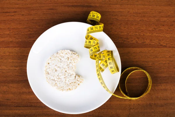 One waffle rice on a plate and measuring tape. — Stock Photo, Image