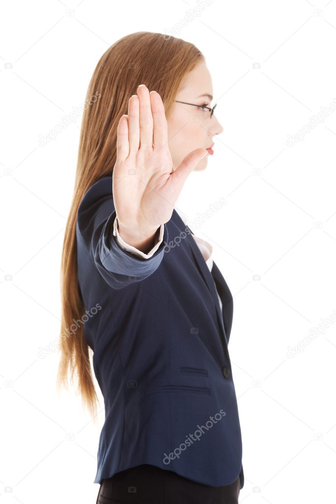 Beautiful business woman showing stop gesture by hand.