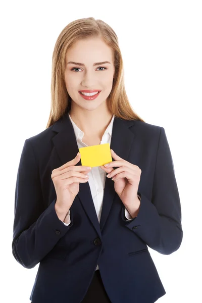 Beautiful caucasian business woman holding yellow empty personal card — Stock Photo, Image