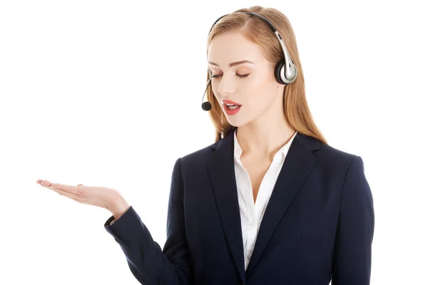 Beautiful causual business woman at call center is pointing on copy space — Stock Photo, Image