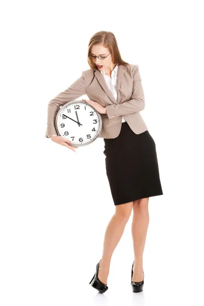 Young caucasian business woman holding clock. Stock Image