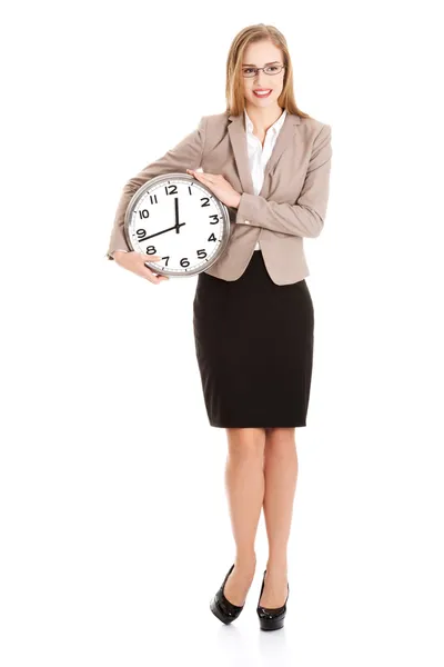 Young caucasian business woman holding clock. Stock Picture