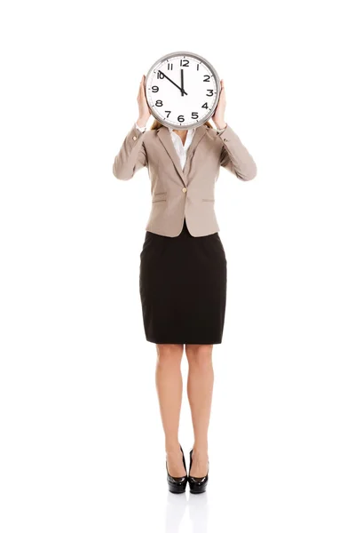 Beautiful caucasian business woman with clock on face. Stock Photo