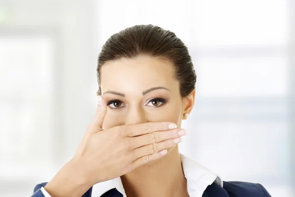 Business woman covering with hand her mouth, — Stock Photo, Image