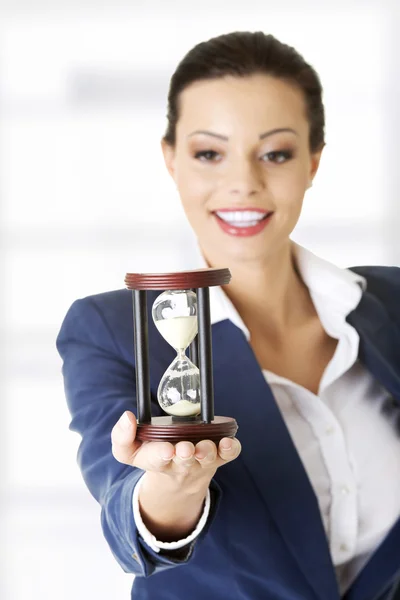 Young business woman with hourglass — Stock Photo, Image