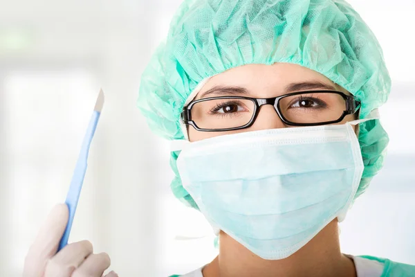 Doctor or nurse with mask and cap — Stock Photo, Image