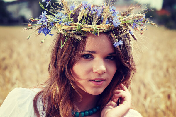 Beautiful young girl in summer field