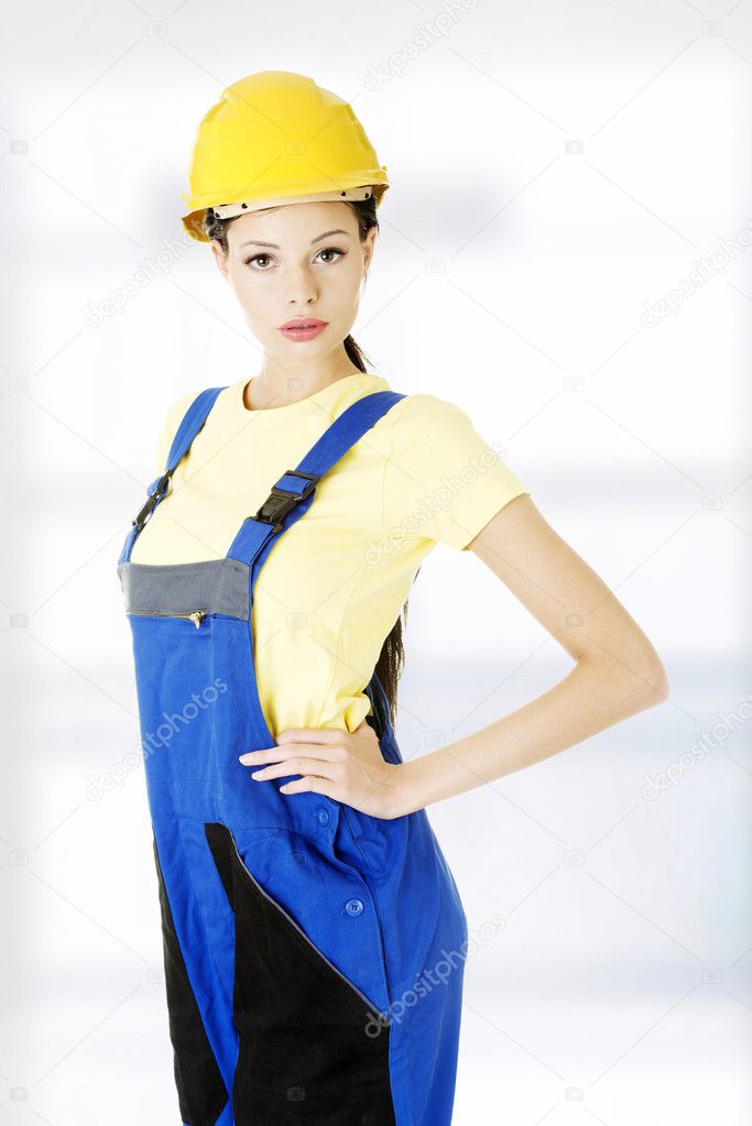 Beautiful young worker woman in protective clothes.