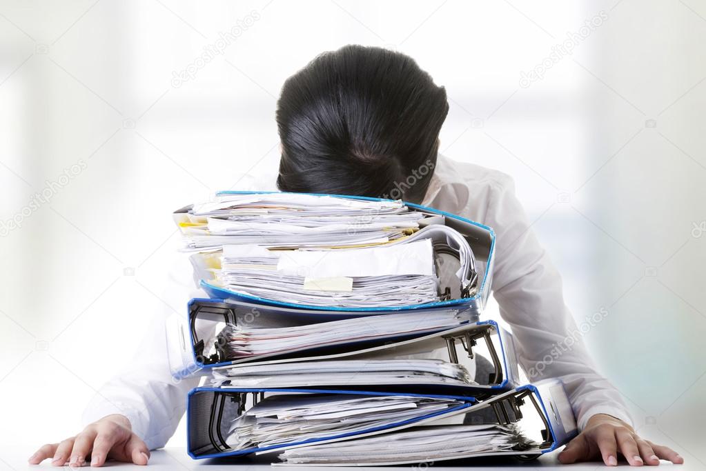 To much work to do. Sad woman with ringbinders