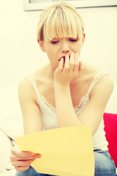 Worried woman's reading letter. — Stock Photo, Image