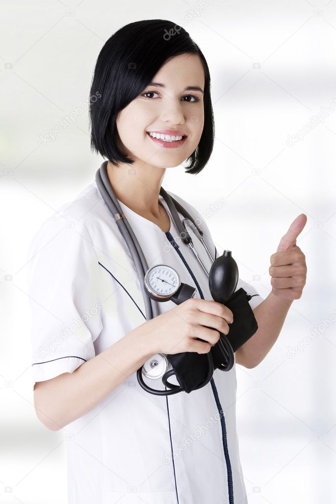 Woman doctor with blood pressure gauge